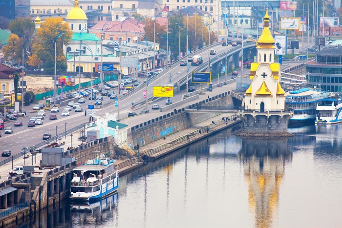 Cityscape with bridge, river, and church in Ukraine