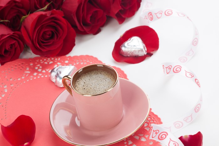 Coffee cup with roses and chocolates