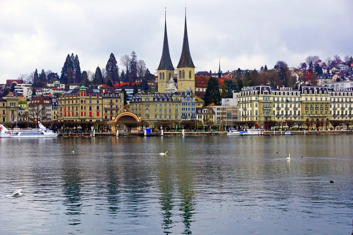 Lucerne, Switzerland cityscape with river and swans