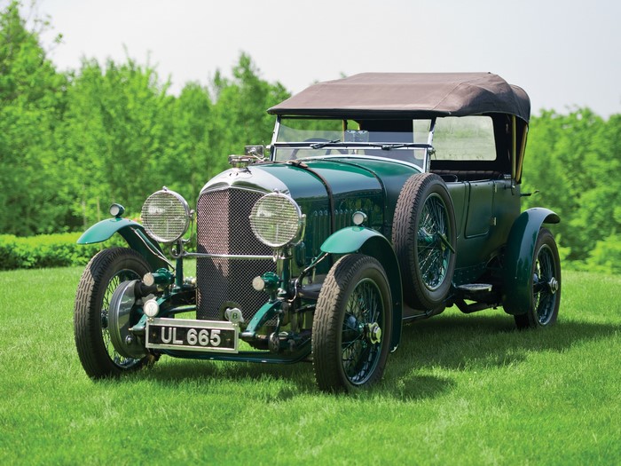 Green vintage Bentley car on grass