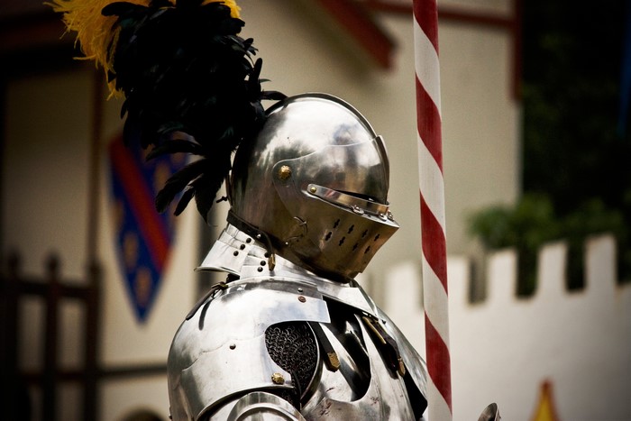 Knight in full armor with a feathered helmet