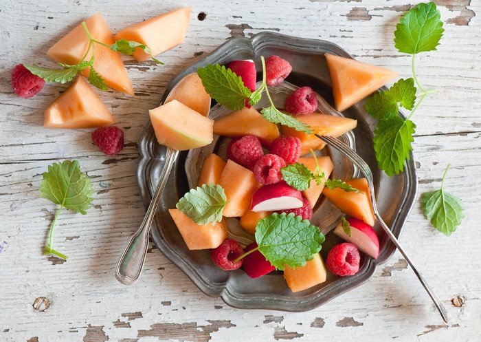 Fruit Salad with Cantaloupe, Raspberries, and Radish on a Plate