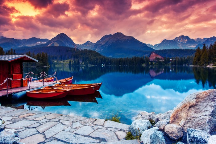 Boats on a lake with mountains and a lodge in Slovakia