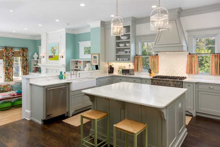 Modern kitchen with island, farmhouse sink, and gas range