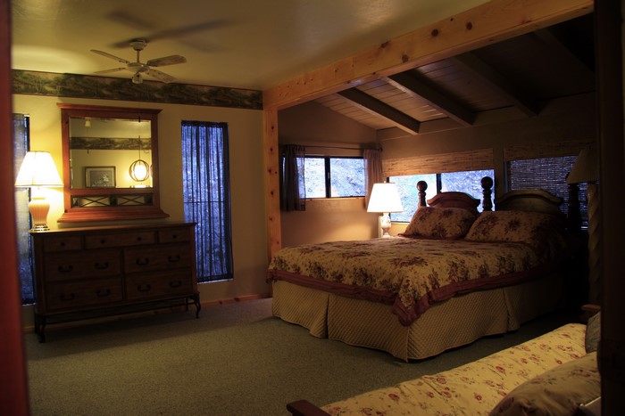 Bedroom with dresser, bed, and lamps