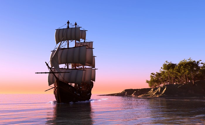 Sailing ship on the sea at sunset