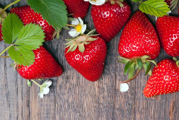 Strawberries with leaves and flowers
