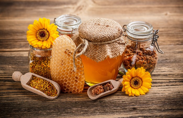 Honey, Bee Pollen, and Honeycomb on Wooden Table