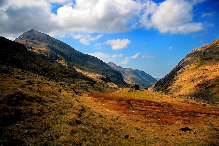 Mountain valley with golden grass and blue sky