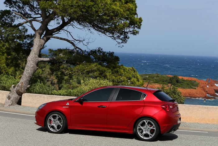 Red Alfa Romeo Giulietta QV on a coastal road
