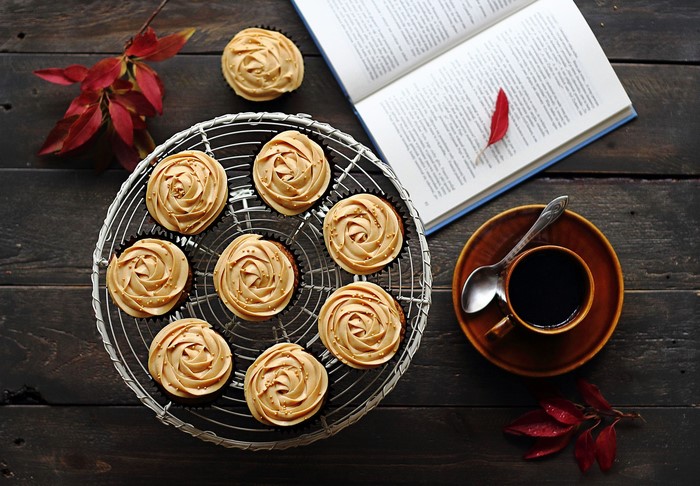 Cupcakes with coffee and an open book