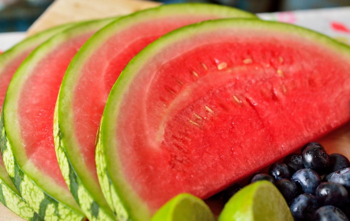 Slices of watermelon with blueberries and lime