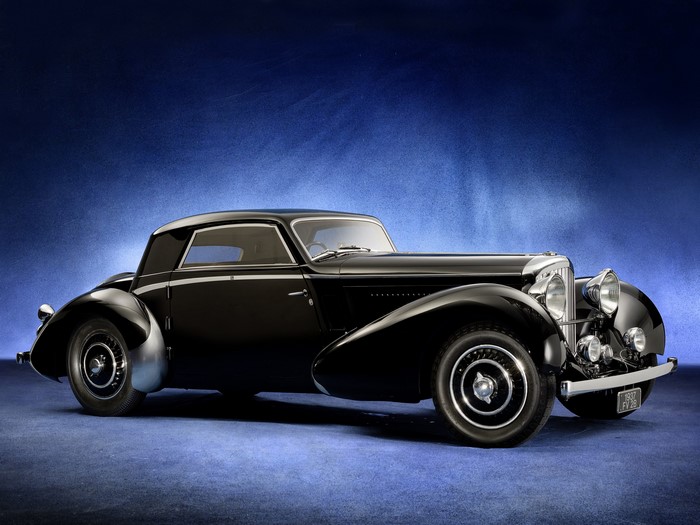 Black 1937 Bentley coupe on a blue background