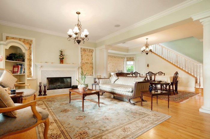 Living room with fireplace, sofa, and dining area