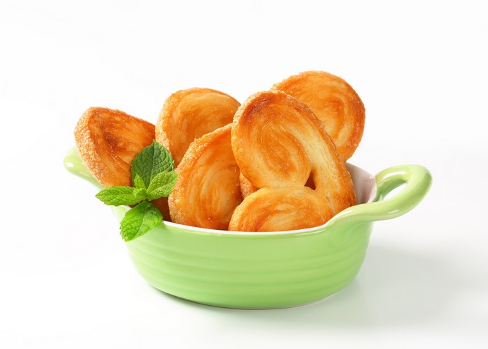 Palmiers pastries in a green bowl with mint