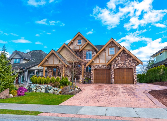 Luxury Stone and Wood House with Stamped Concrete Driveway