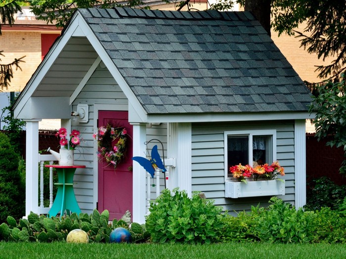 Playhouse with flowers and garden decorations