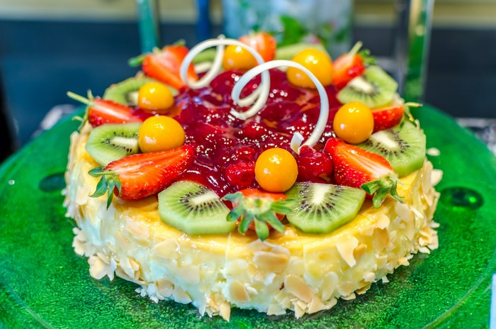 Fruit cake with strawberries, kiwi, and gooseberries