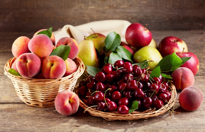 Fruit in wicker baskets: Peaches, Apples, Cherries