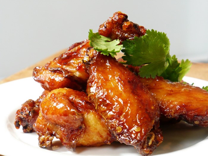 Glazed chicken wings with cilantro garnish