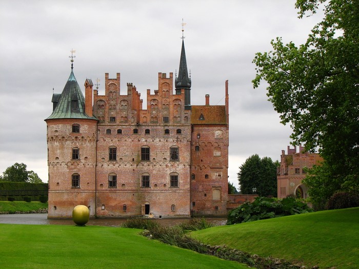 Egeskov Castle in Denmark with a golden orb sculpture
