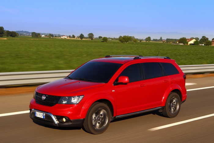 Red 2014 Fiat Freemont Cross driving on a road