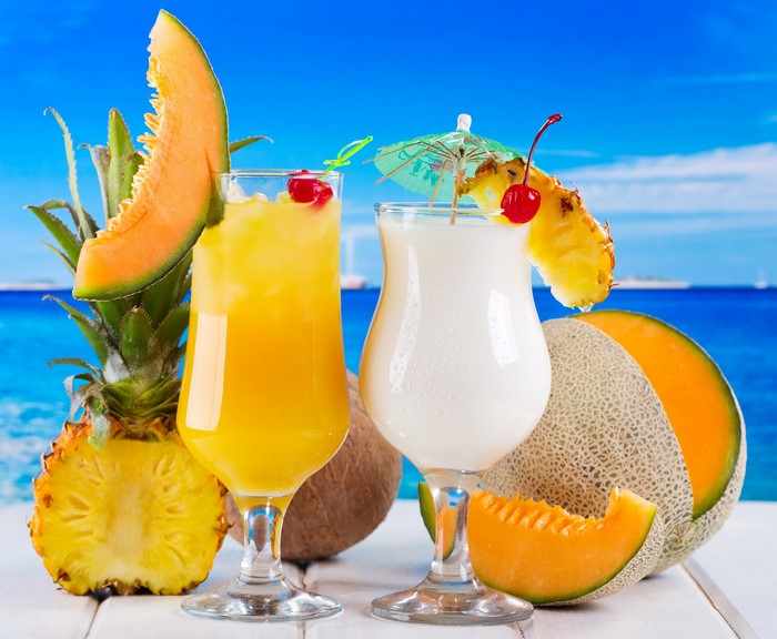 Tropical Drinks with Fruits and Ocean Background