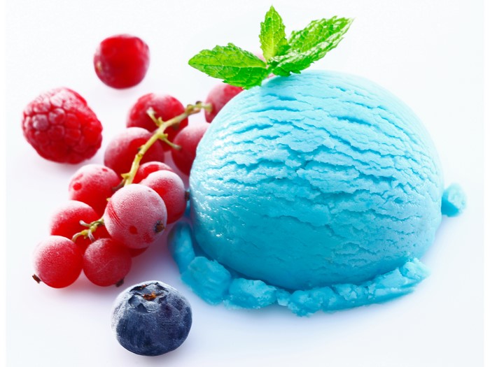 Blue ice cream scoop with berries and mint