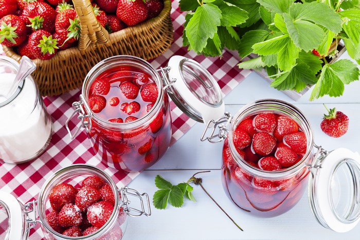 Strawberries in jars with sugar and basket