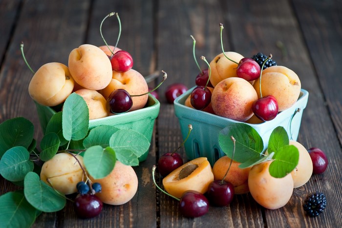 Apricots and cherries in baskets