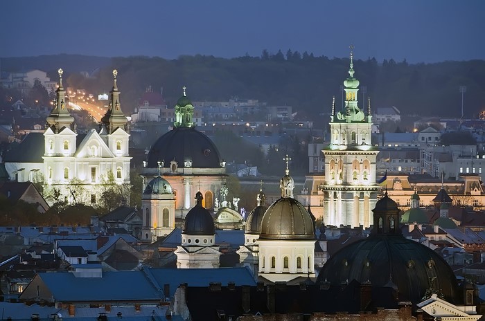 Lviv cityscape at night with illuminated churches and domes
