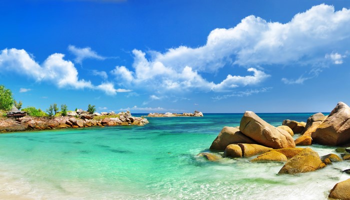 Tropical beach with clear turquoise water and large rocks