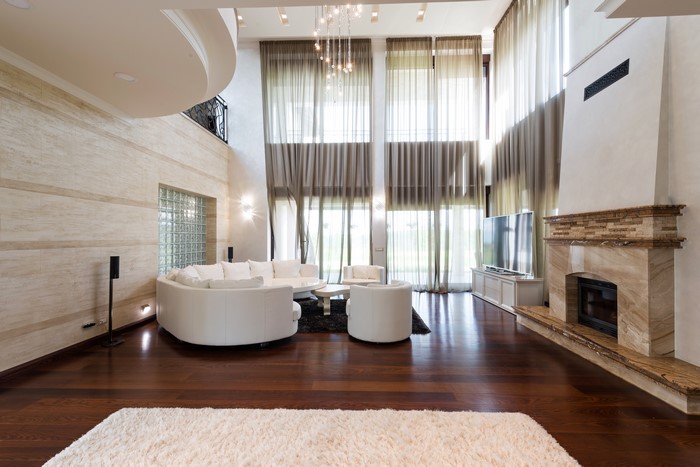 Luxury living room with fireplace and large windows