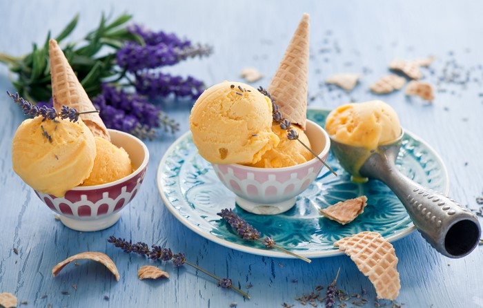 Orange ice cream with lavender and waffle cones