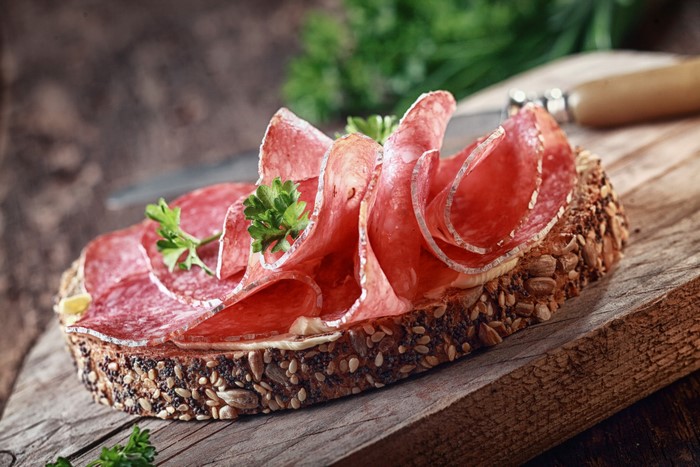 Salami sandwich on seeded bread with parsley