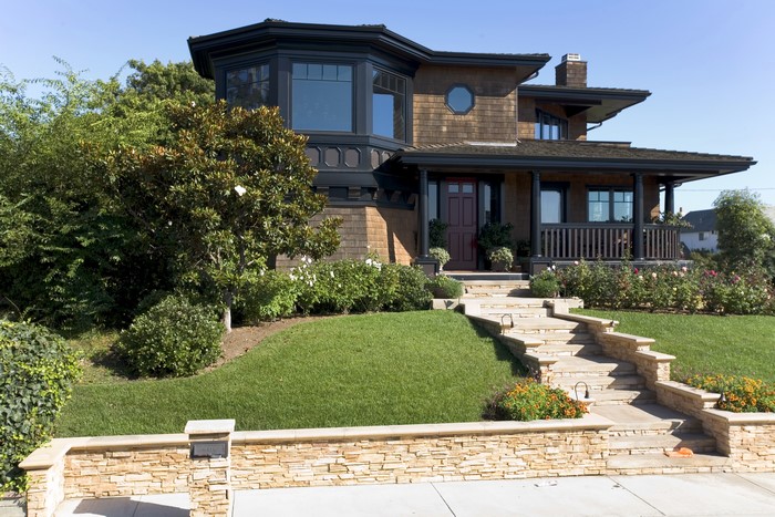 Craftsman style house with stone steps and landscaping