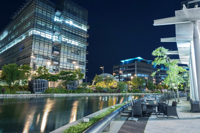 Modern buildings and river at night