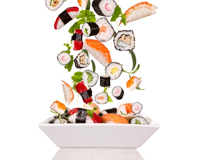 Sushi and seafood falling into a bowl