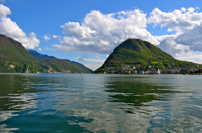 Lake Lugano with mountains and houses in Switzerland