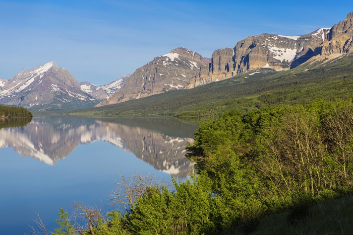 Mountains reflected in a lake in Glacier National Park, USA