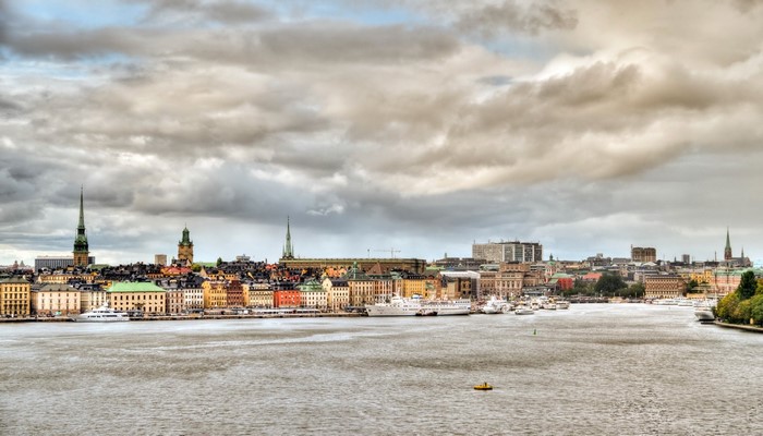 Stockholm cityscape with river and cloudy sky