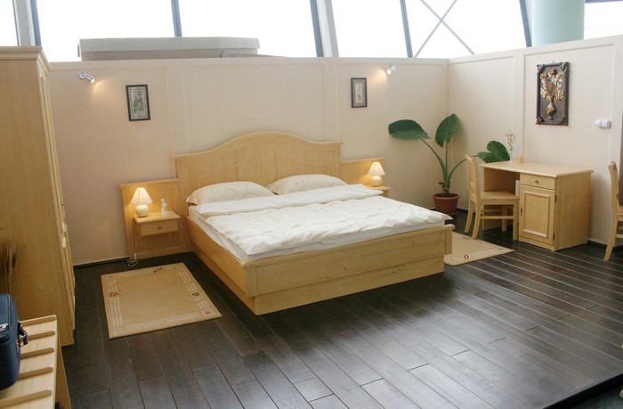 Bedroom with wooden furniture and dark floor
