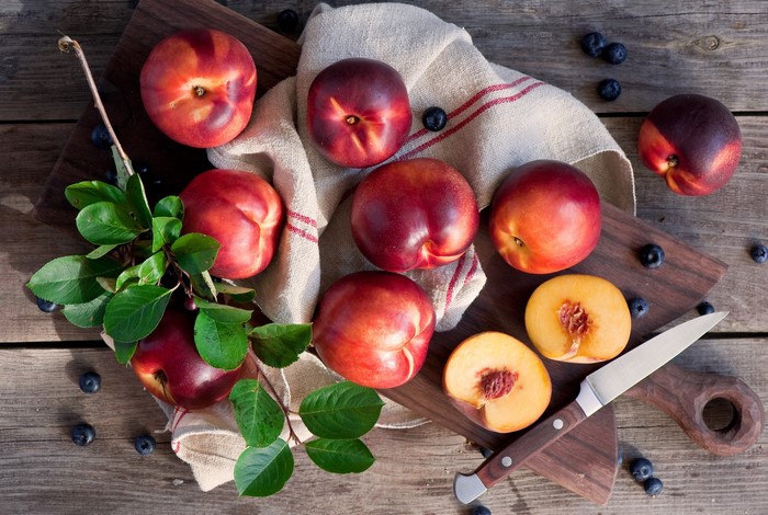Nectarines and blueberries on a wooden table