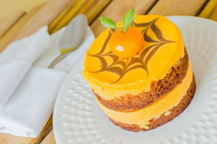 Orange cake with chocolate swirl and garnish