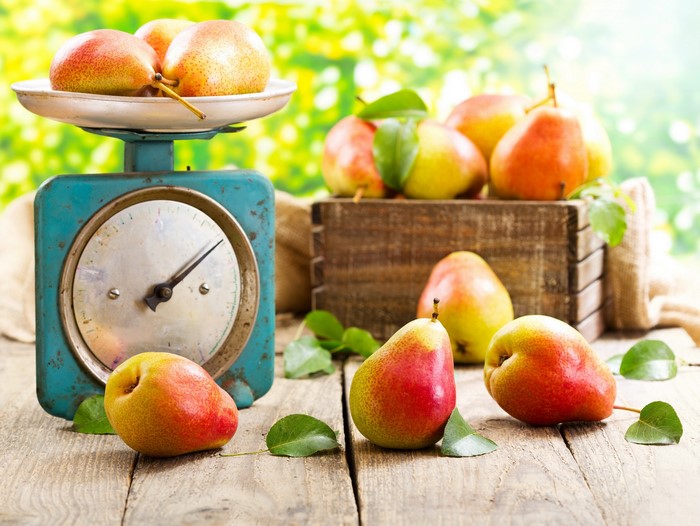 Pears on a vintage scale and in a wooden crate