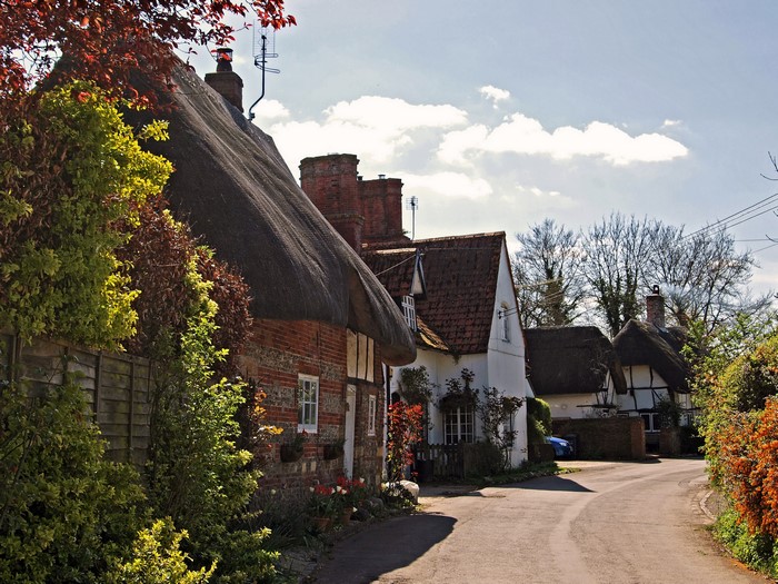 Thatched roof cottages on a village street in Nether Wallop, England