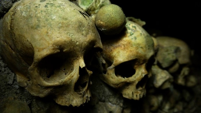 Many skulls in a dark place