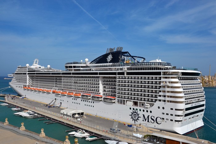 MSC Preziosa cruise liner docked at a marina