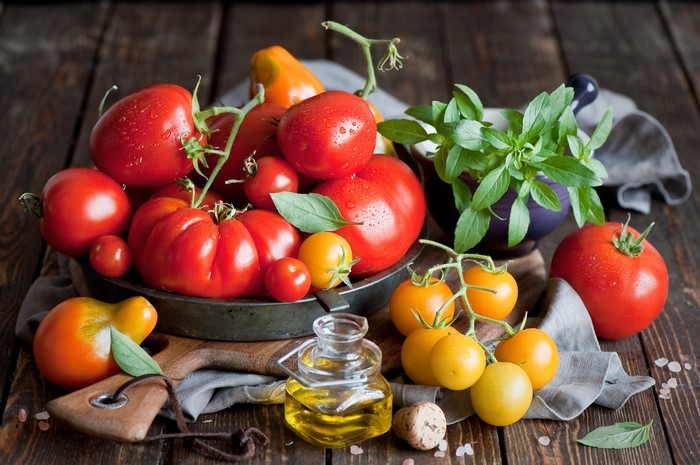 Tomatoes and basil on a wooden table