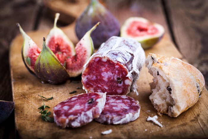 Sausage, Figs, and Bread on a Wooden Board